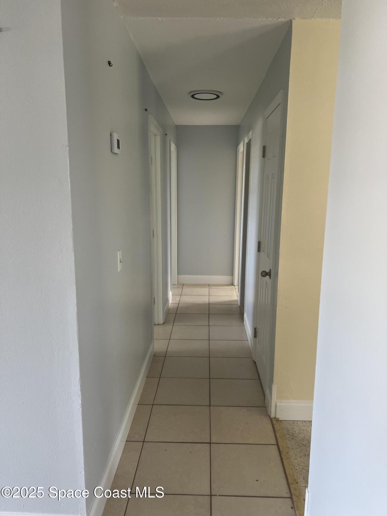 2906 Rollins Street Melbourne, FL 32901 - Photo 6 of 12 a view of hallway with a window and a refrigerator