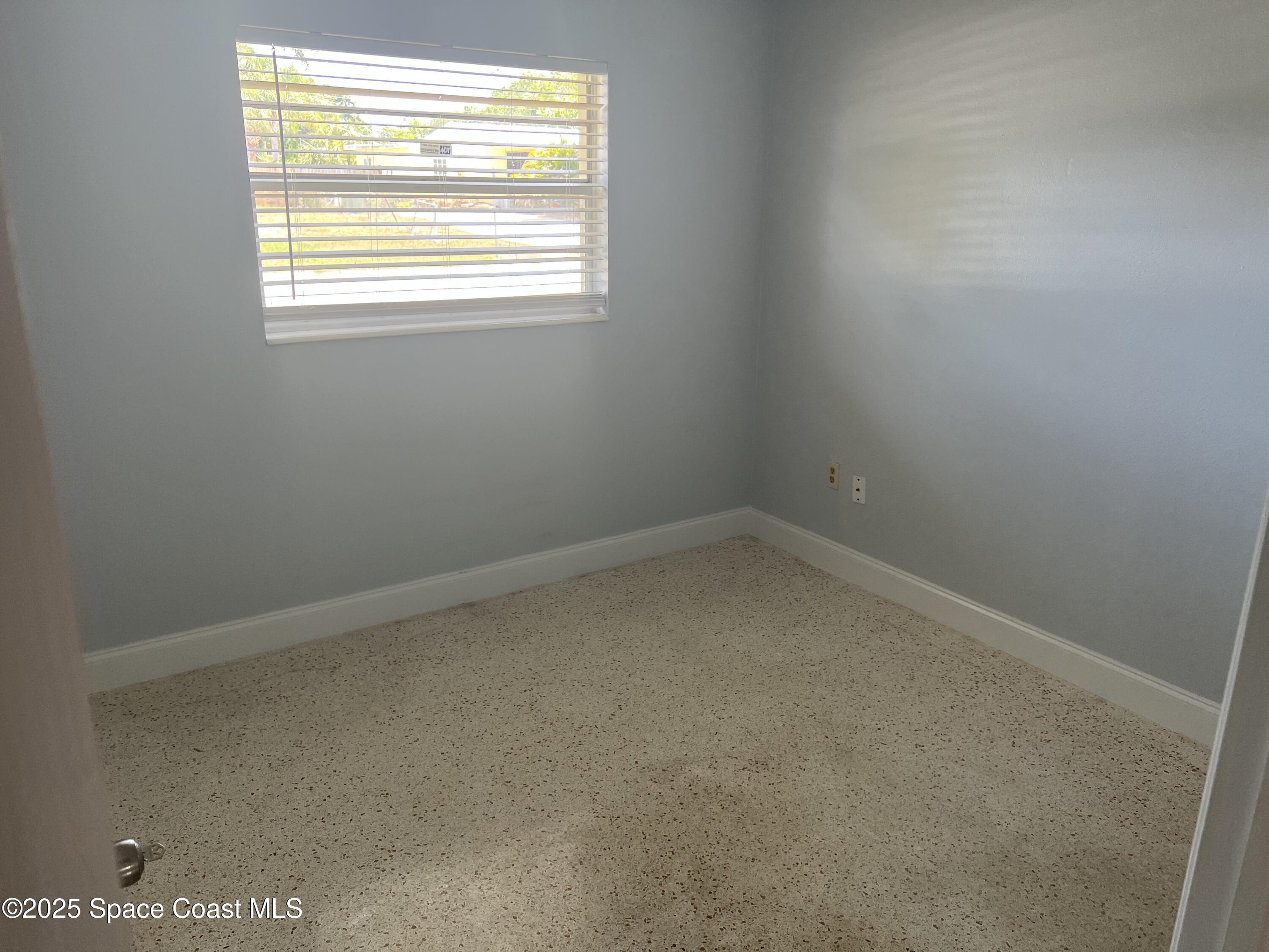 2906 Rollins Street Melbourne, FL 32901 - Photo 7 of 12 an empty room with a window