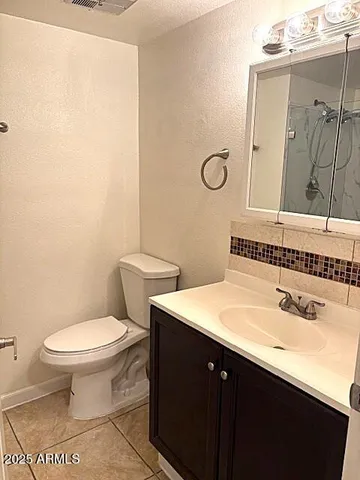a bathroom with a sink toilet and mirror