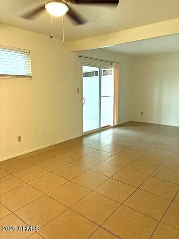 a view of an empty room and a window