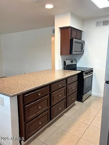 a kitchen with a stove microwave and sink