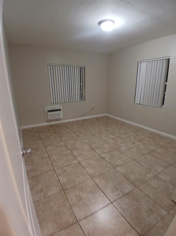5759 Southwest 61st Street Miami, FL 33143 - Photo 7 of 9 an empty room with windows