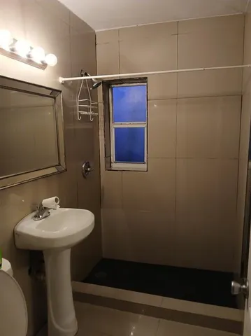 a bathroom with a sink toilet and mirror