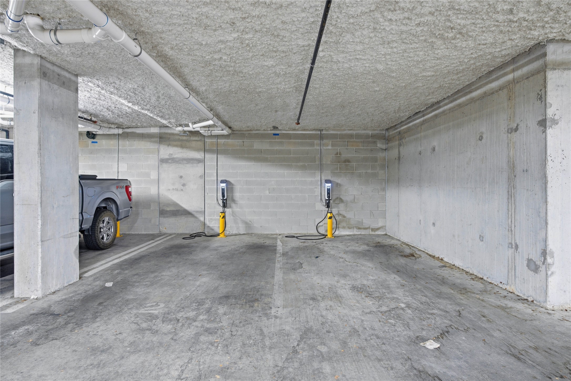 2500 Longview Street, Unit 219 Austin, TX 78705 - Photo 25 of 40 Parking deck featuring concrete block wall