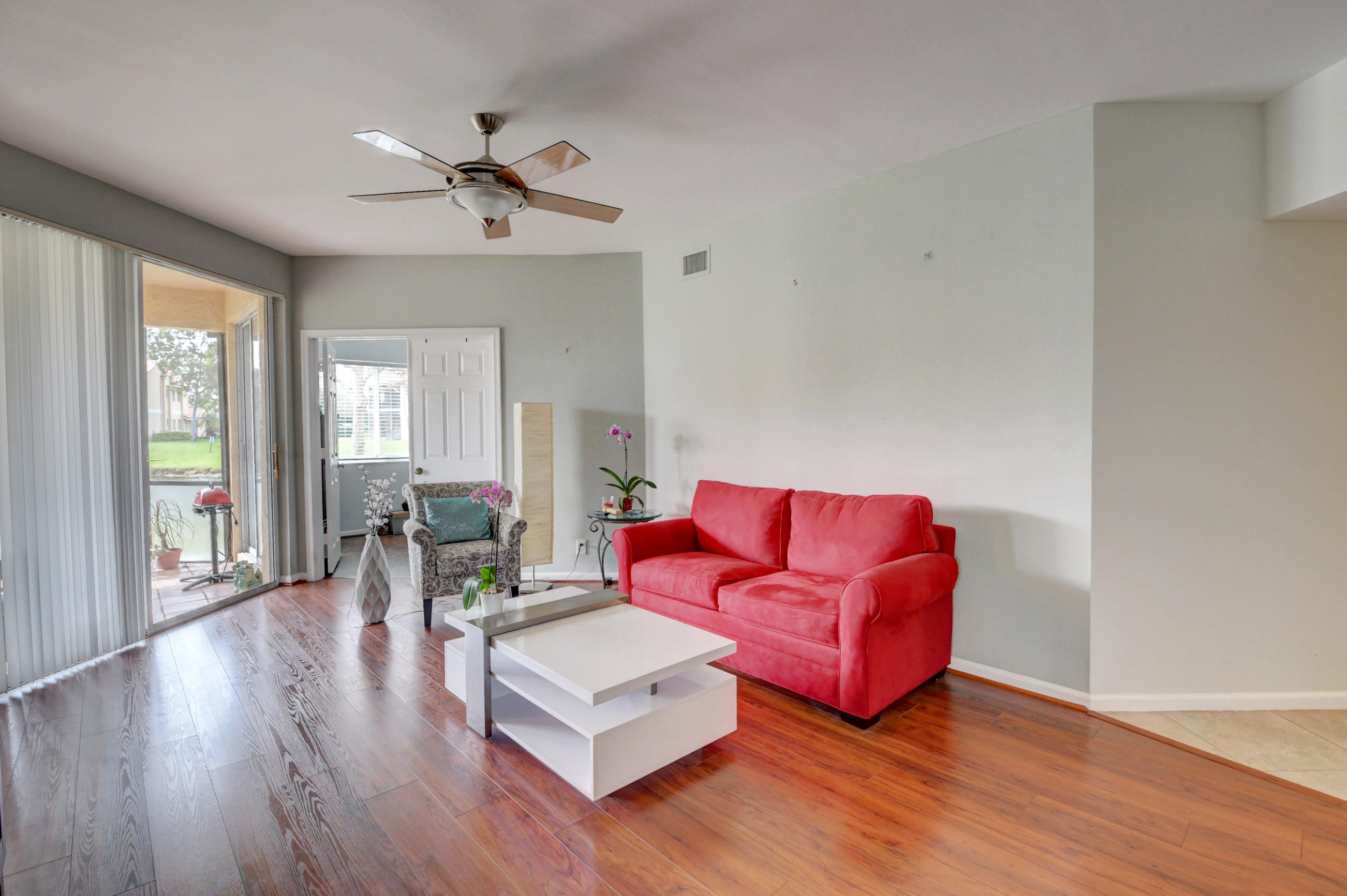 23061 Aqua View, Unit 1 Boca Raton, FL 33433 - Photo 11 of 29 a living room with furniture wooden floor and a large window