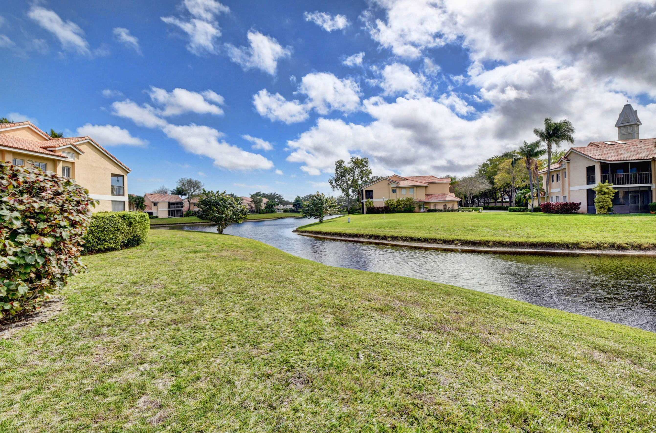 23061 Aqua View, Unit 1 Boca Raton, FL 33433 - Photo 20 of 29 a view of a fountain in front of a house with a big yard