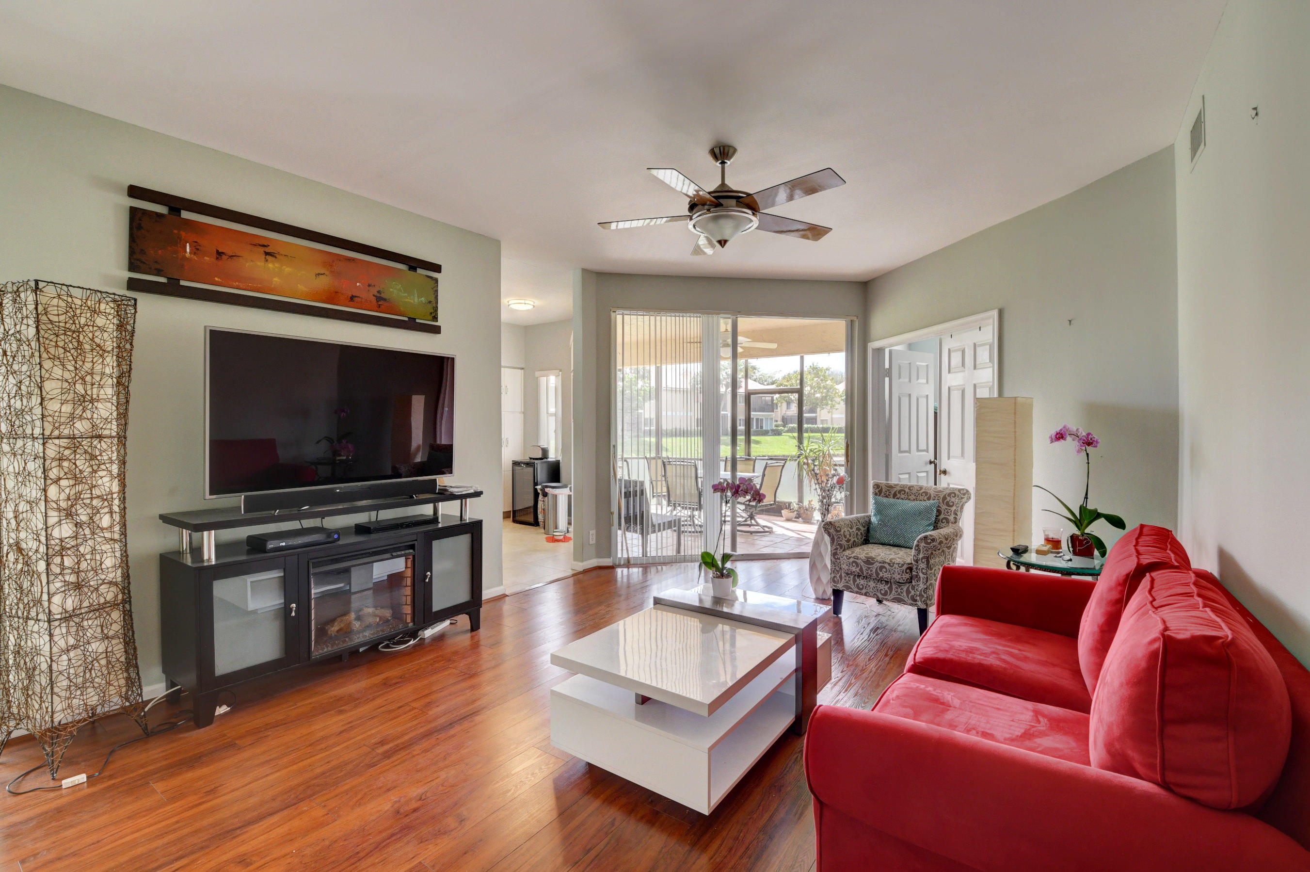 23061 Aqua View, Unit 1 Boca Raton, FL 33433 - Photo 8 of 29 a living room with furniture and a flat screen tv