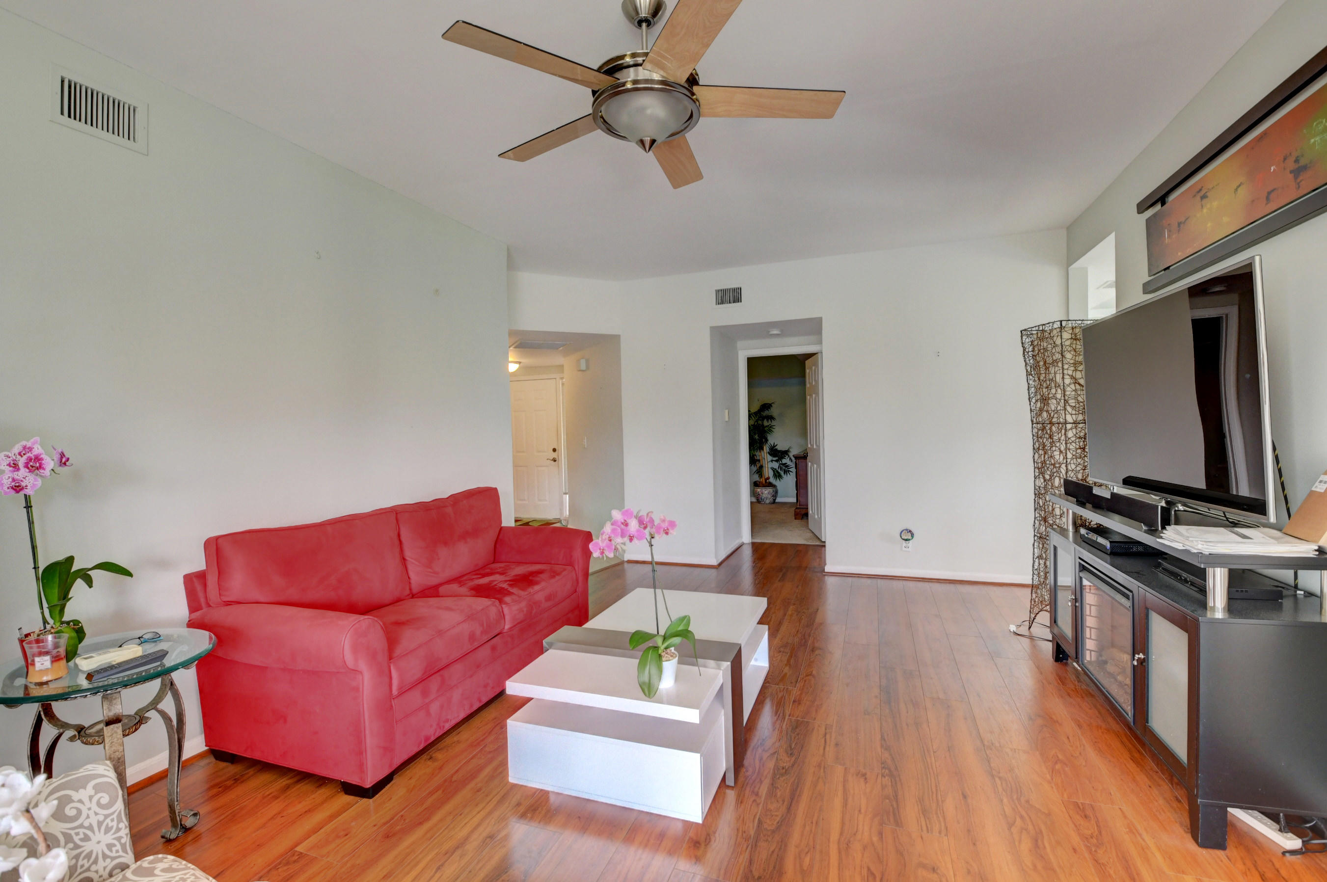 23061 Aqua View, Unit 1 Boca Raton, FL 33433 - Photo 9 of 29 a living room with furniture and a flat screen tv