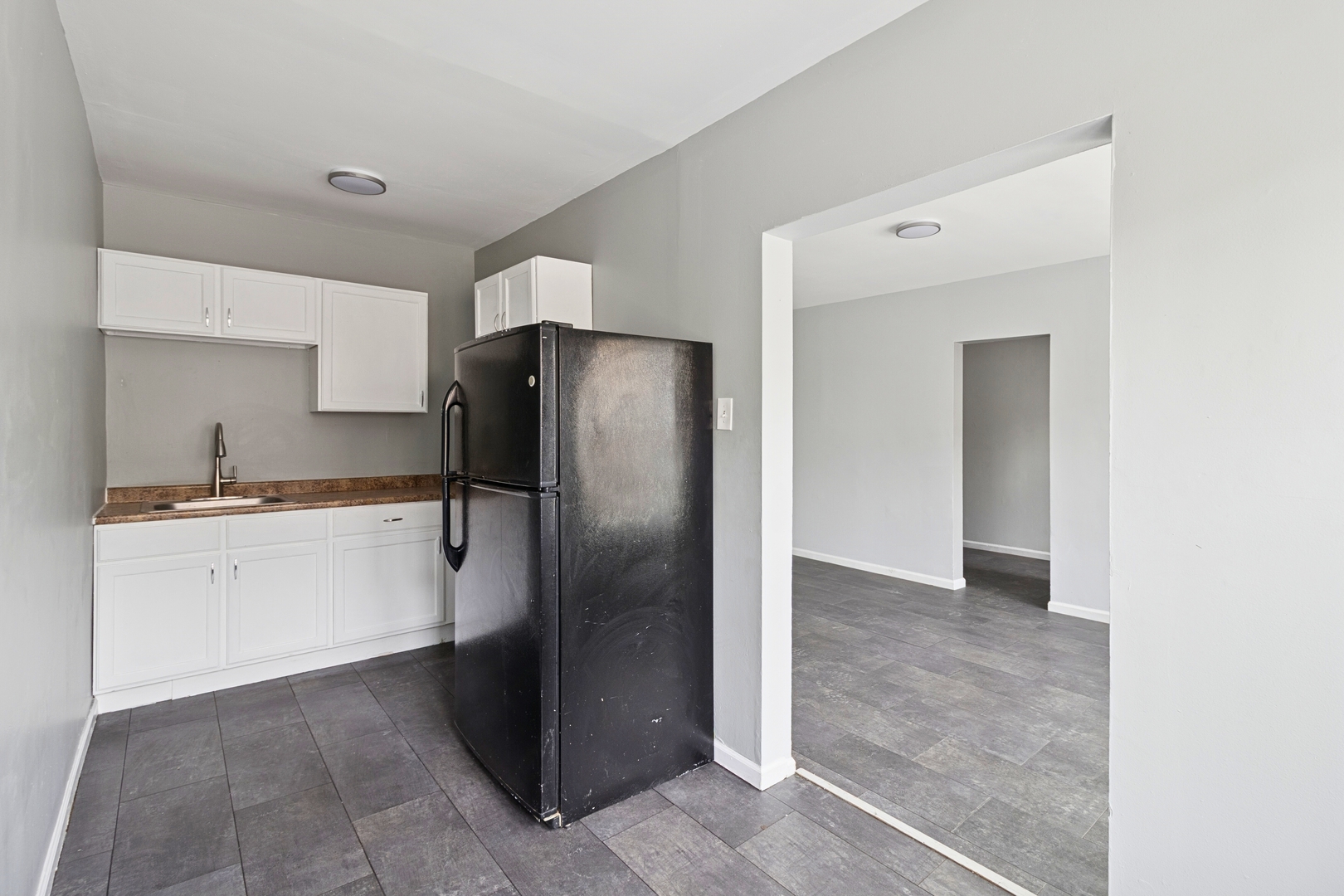 6228 South Western Avenue, Unit 203 Chicago, IL 60636 - Photo 8 of 11 a kitchen with a refrigerator and white cabinets