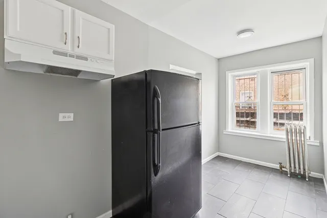 a white refrigerator freezer sitting in a kitchen