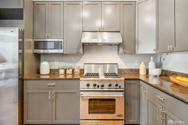 a kitchen with cabinets and a stove top oven