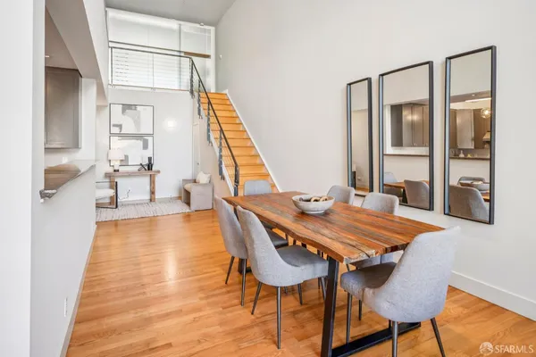 a dining room with furniture and wooden floor