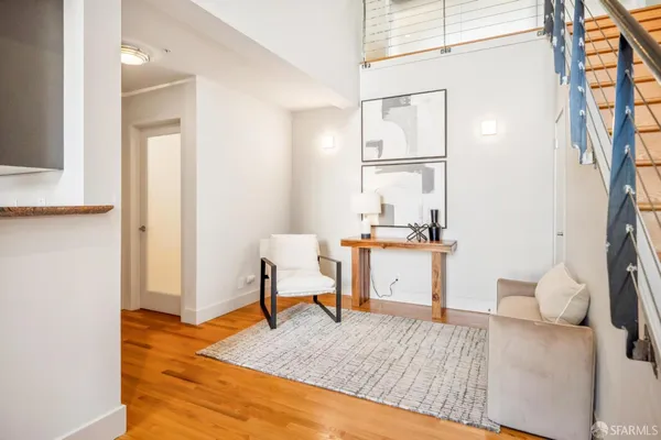 a living room with furniture and a wooden floor