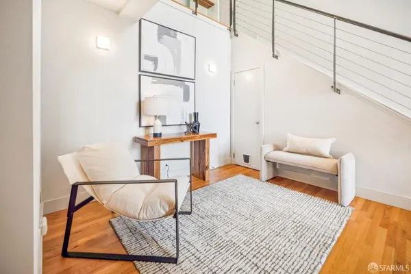 a bedroom with furniture and a rug