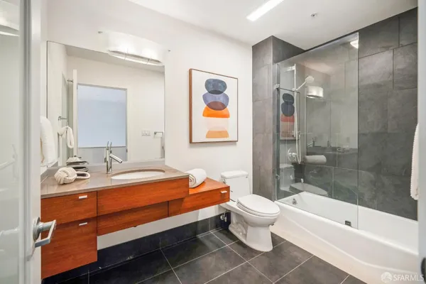 a bathroom with a sink mirror toilet and bathtub