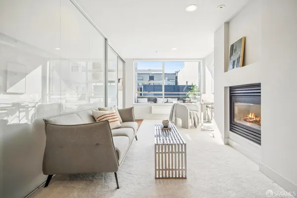 a living room with furniture a fireplace and a table
