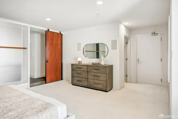 a bedroom with a bed and a dresser