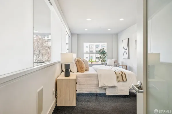 a bedroom with bed and window