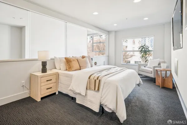 a spacious bedroom with a bed and a couch