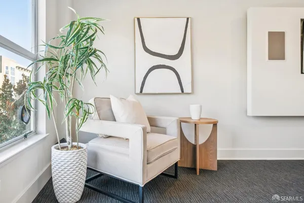 a living room with furniture and a potted plant
