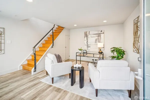 a living room with furniture and wooden floor