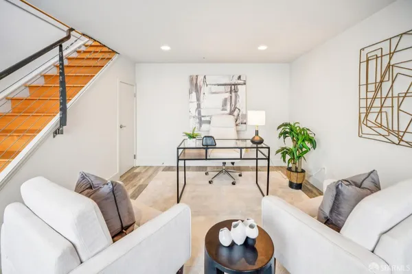 a living room with furniture and a potted plant