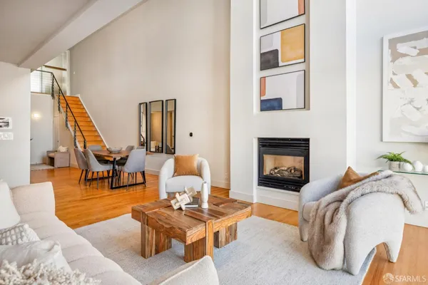a living room with furniture a rug and a fireplace