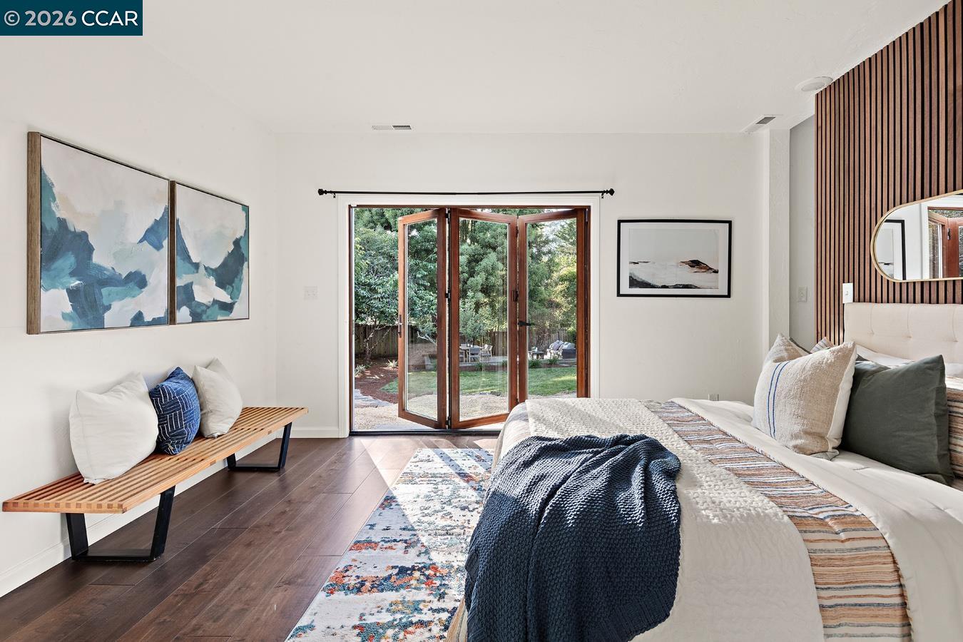 85 Ardmore Road Kensington, CA 94707 - Photo 19 of 45 a bedroom with a bed and wooden floor