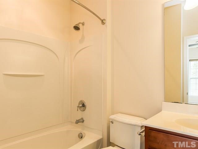 209 Amiable Loop Cary, NC 27519 - Photo 13 of 25 a bathroom with a granite countertop sink toilet and shower