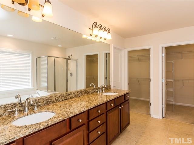 209 Amiable Loop Cary, NC 27519 - Photo 15 of 25 a bathroom with a granite countertop double vanity sink and a mirror