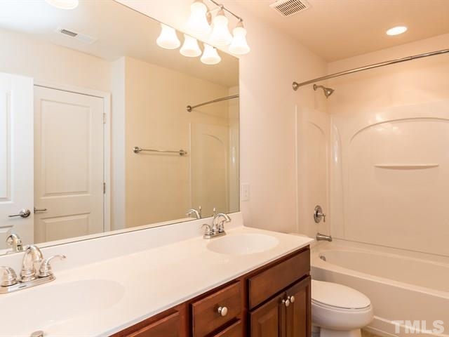 209 Amiable Loop Cary, NC 27519 - Photo 18 of 25 a bathroom with a sink a toilet and shower