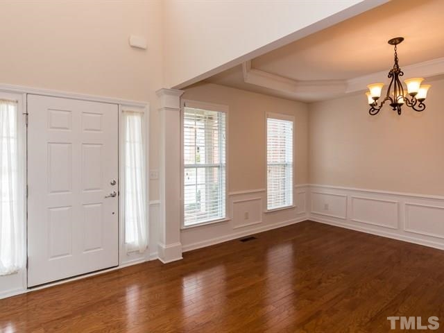 209 Amiable Loop Cary, NC 27519 - Photo 2 of 25 an empty room with wooden floor and windows