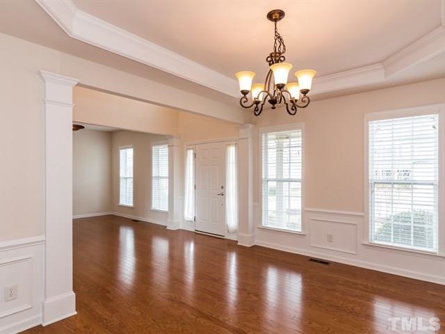 209 Amiable Loop Cary, NC 27519 - Photo 4 of 25 a view of a room with wooden floor and chandelier