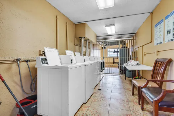 a utility room with multiple dryer and washer