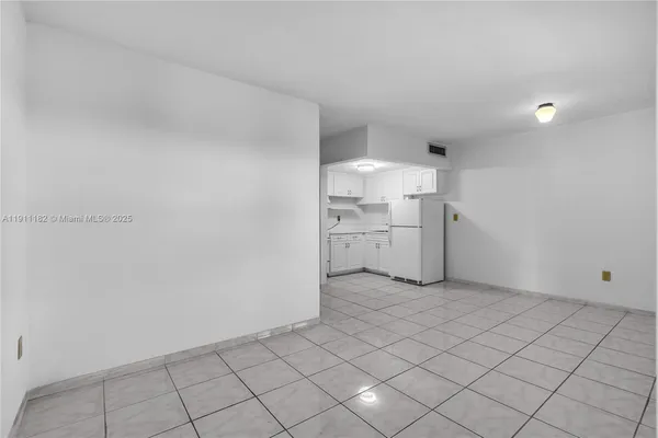 a view of a kitchen with white cabinets