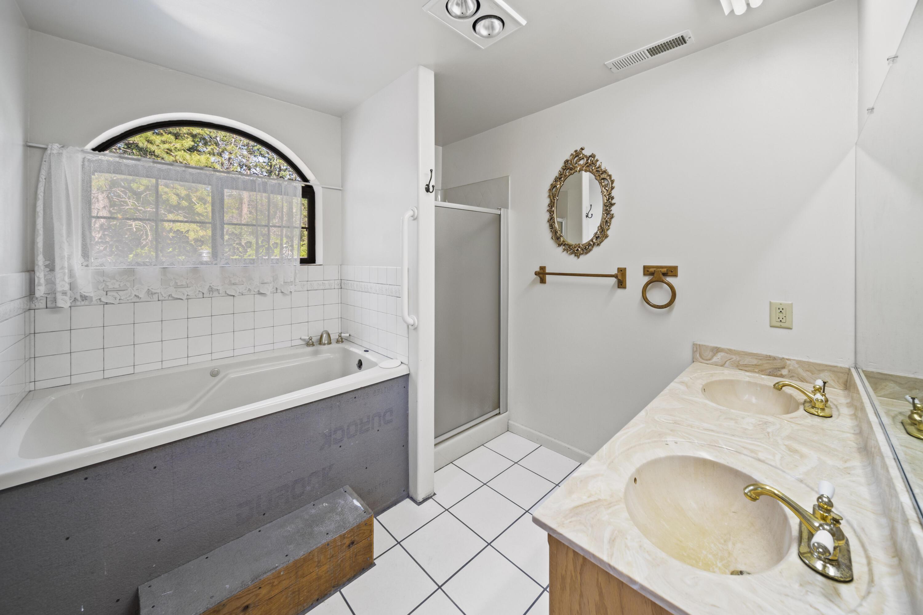 21110 Rolling Hills Road Manton, CA 96059 - Photo 12 of 34 a bathroom with a bathtub sink and mirror