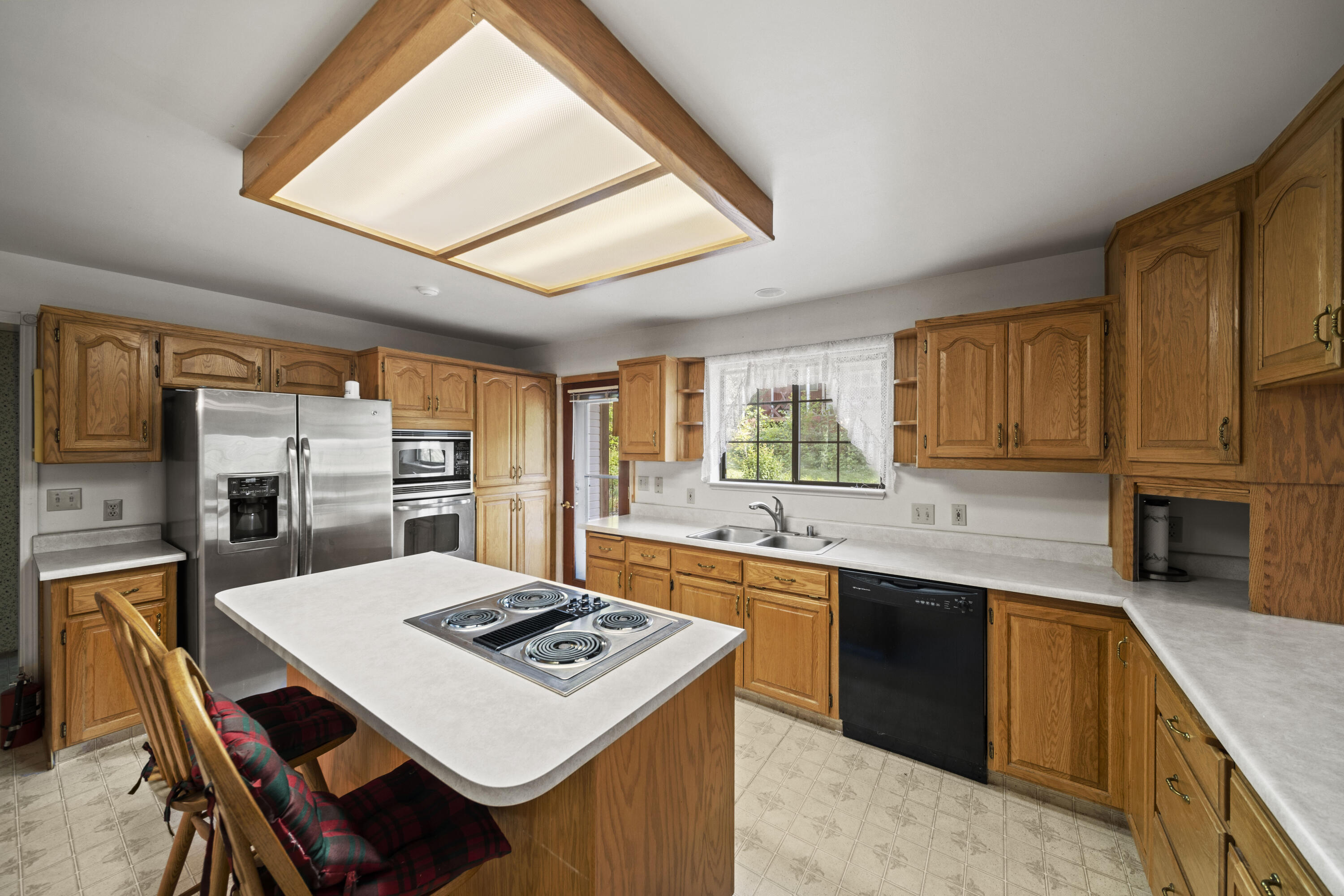 21110 Rolling Hills Road Manton, CA 96059 - Photo 6 of 34 a kitchen that has a sink a stove a table and chairs in it