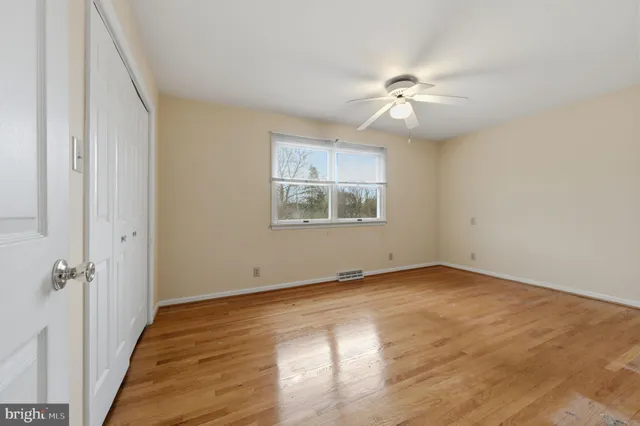 a view of an empty room and wooden floor