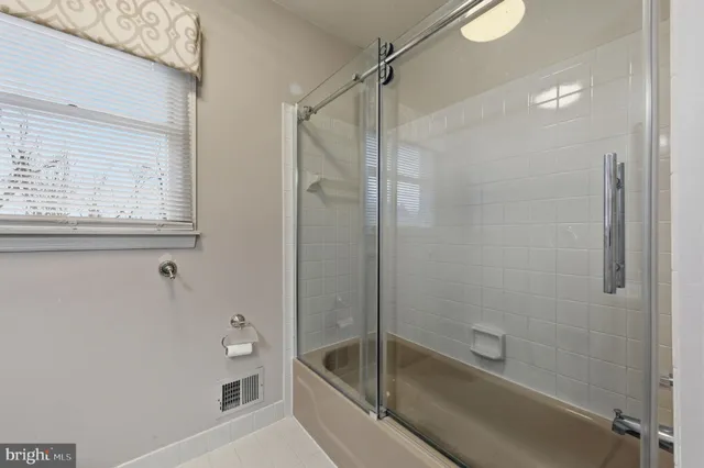 a en suite bathroom with a granite countertop sink mirror and toilet