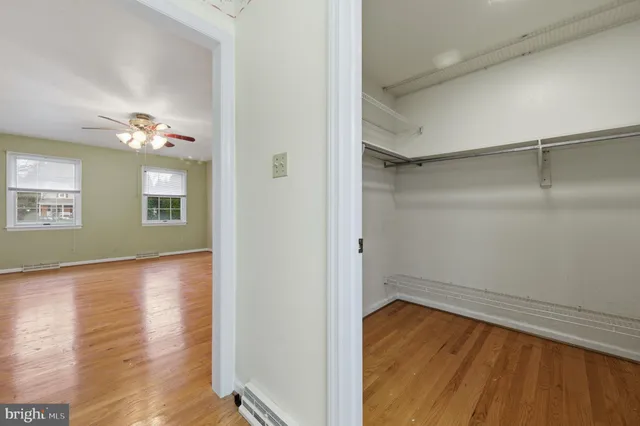 an empty room with white walls and tiles