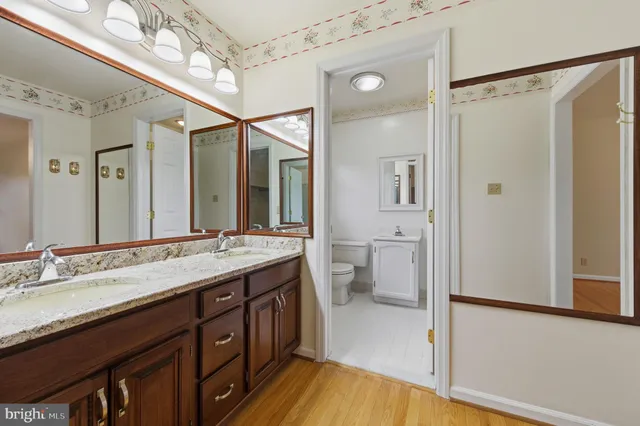 a view of a balcony with wooden floor and fence