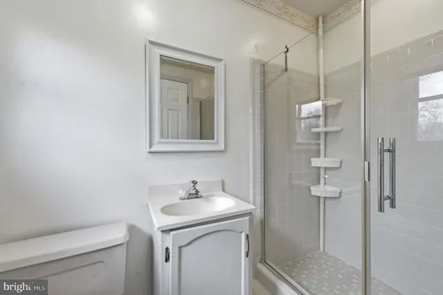 a view of a green field with wooden fence