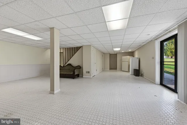 an aerial view of a house with a yard and lake view