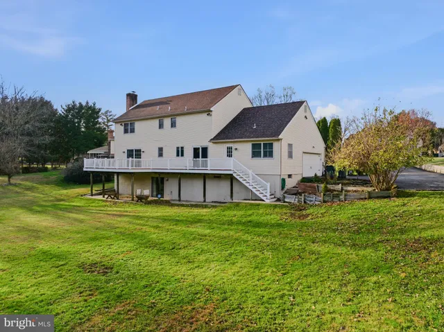 an aerial view of a house with swimming pool and lake view