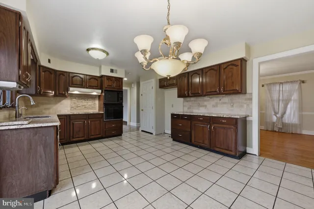 a kitchen with stainless steel appliances granite countertop a stove microwave and cabinets