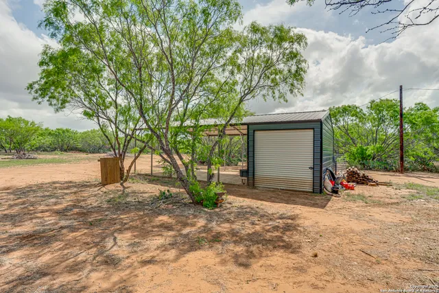 a view of a house with a tree and yard