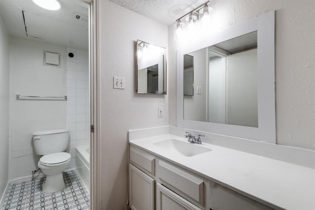 11311 Audelia Road, Unit 239 Dallas, TX 75243 - Photo 1 of 12 a bathroom with a sink toilet vanity and shower