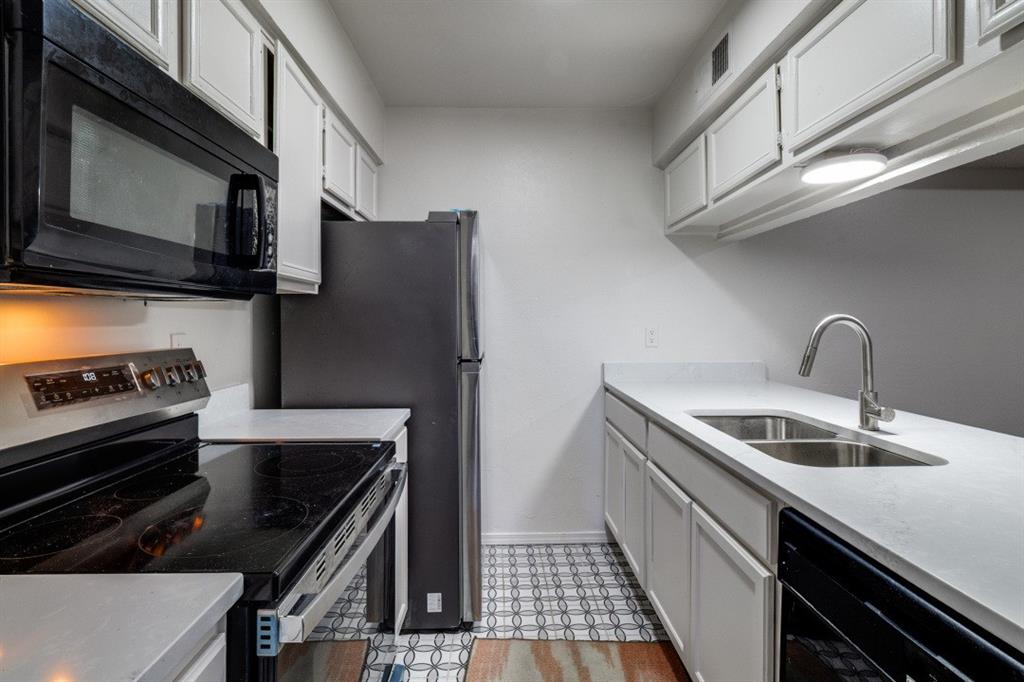 11311 Audelia Road, Unit 239 Dallas, TX 75243 - Photo 7 of 12 a kitchen with a sink and stainless steel appliances
