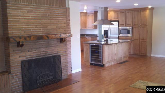 2255 Riviera Street Reno, NV 89509 - Photo 4 of 13 a kitchen with stainless steel appliances kitchen island granite countertop a stove top oven a sink and a refrigerator