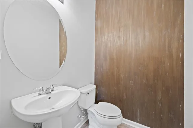 a bathroom with a toilet a sink and a mirror